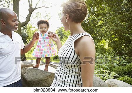 Picture - Family playing together in park. Fotosearch