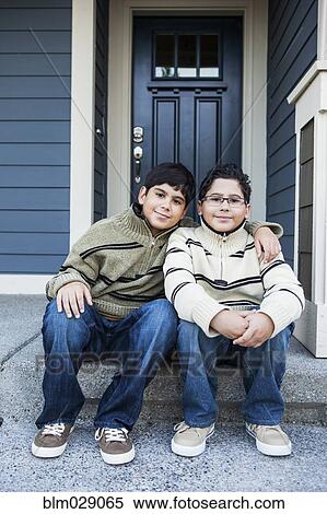 Hispanic boys hugging on front stoop View Large Photo Image Stock Photography - Hispanic boys hugging on front stoop. Fotosearch