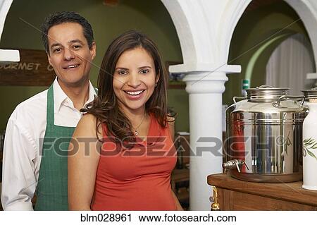 Hispanic couple smiling in shop View Large Photo Image Stock Image - Hispanic couple smiling in shop. Fotosearch