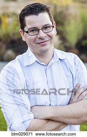 Hispanic man smiling outdoors View Large Photo Image Stock Image - Hispanic man smiling outdoors. Fotosearch