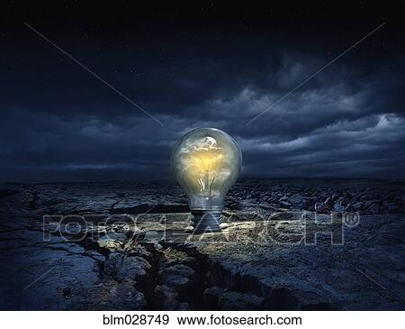 Illuminated light bulb in cracked earth View Large Photo Image Stock Photo - Illuminated light bulb in cracked earth. Fotosearch