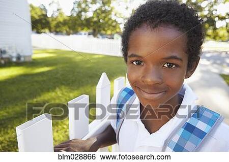 Mixed race boy smiling on suburban street View Large Photo Image Stock Photograph - Mixed race boy smiling on suburban street. Fotosearch
