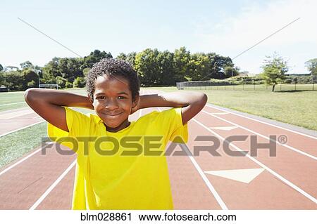 Mixed race boy smiling on track View Large Photo Image Stock Image - Mixed race boy smiling on track. Fotosearch