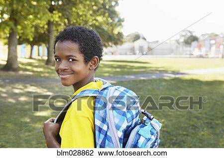 Stock Image - Mixed race boy smiling outdoors. Fotosearch