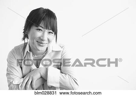 Stock Image - Mixed race businesswoman smiling. Fotosearch