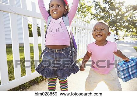 Stock Photo - Mixed race girls playing on suburban street. Fotosearch
