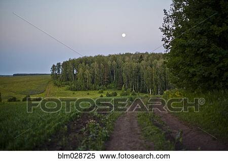 Stock Photography - Moon over rural landscape. Fotosearch