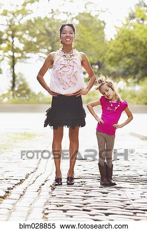 Stock Photography - Mother and daughter posing on city street. Fotosearch