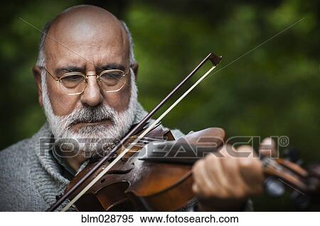 Senior Caucasian man playing violin outdoors View Large Photo Image Stock Photography - Senior Caucasian man playing violin outdoors. Fotosearch
