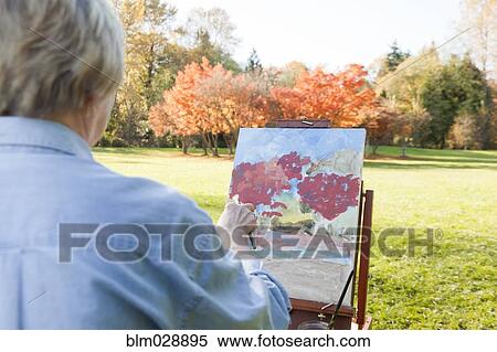Senior woman painting outdoors View Large Photo Image Stock Photography - Senior woman painting outdoors. Fotosearch