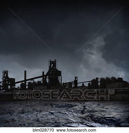 Stock Image - Silhouette of factories against stormy sky, Detroit, Michigan, United States. Fotosearch