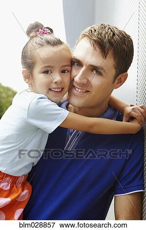 Smiling father holding daughter View Large Photo Image Stock Photo - Smiling father holding daughter. Fotosearch