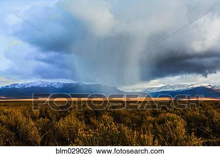 Stock Photograph - Storm clouds moving across rural prairie, Orovada, Nevada, United States. Fotosearch