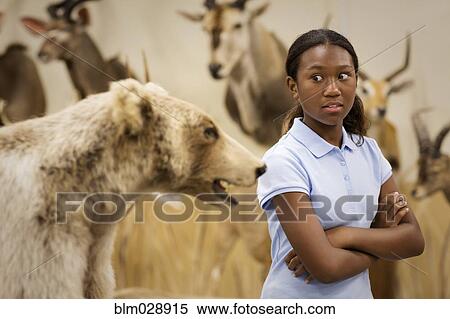 Stock Photography - Student examining stuffed bear in museum. Fotosearch