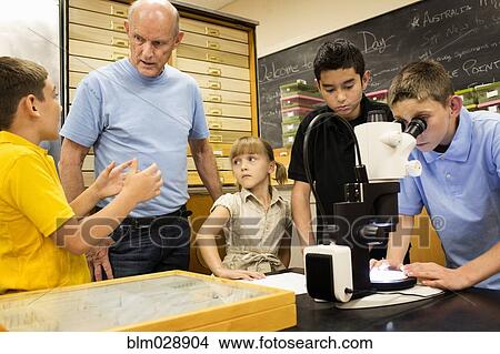 Picture - Teacher talking to students in science lab. Fotosearch