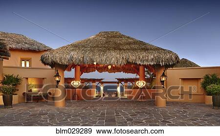 Thatched roof over stone walkway at resort, Cabo San Lucas, BCS, Mexico View Large Photo Image Stock Photo - Thatched roof over stone walkway at resort, Cabo San Lucas, BCS, Mexico. Fotosearch