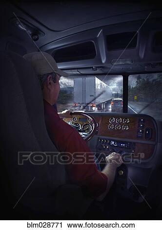 Stock Image - Trucker driving on freeway. Fotosearch