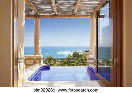 Window overlooking infinity pool and ocean View Large Photo Image Stock Photography - Window overlooking infinity pool and ocean. Fotosearch