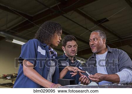 Workers talking in warehouse View Large Photo Image Stock Photography - Workers talking in warehouse. Fotosearch