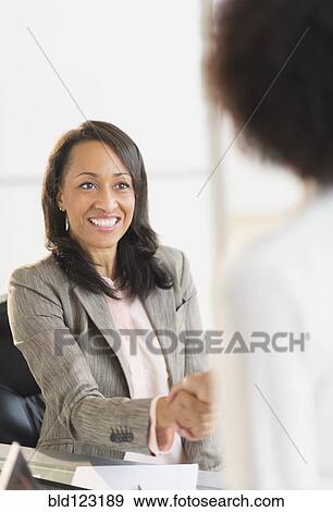 African American businesswomen shaking hands View Large Photo Image Stock Photo - African American businesswomen shaking hands. Fotosearch