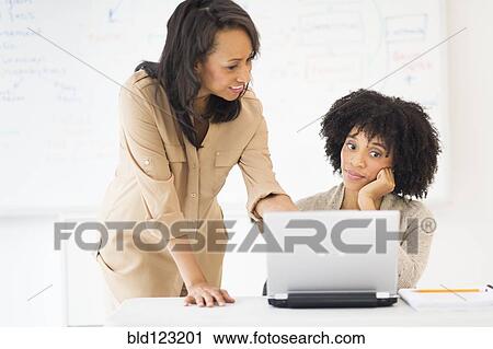 Stock Image - African American businesswomen working together. Fotosearch