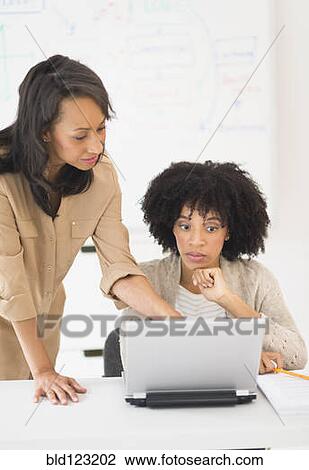Stock Image - African American businesswomen working together. Fotosearch