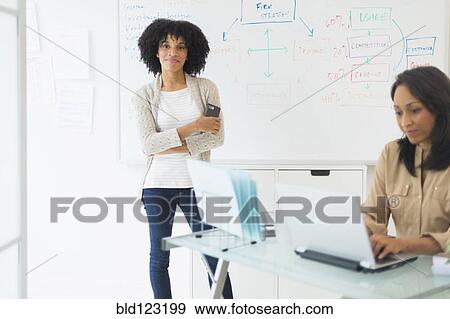 African American businesswomen working in office View Large Photo Image Stock Photo - African American businesswomen working in office. Fotosearch
