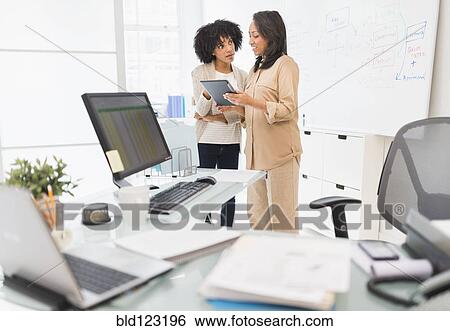 African American businesswomen working in office View Large Photo Image Stock Photograph - African American businesswomen working in office. Fotosearch