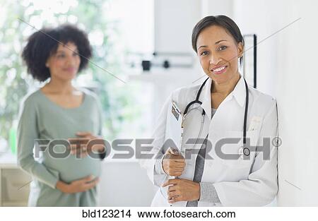 Picture - African American doctor smiling in office. Fotosearch