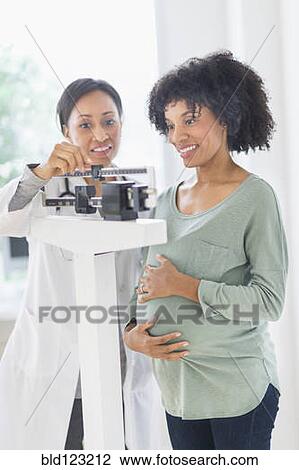 African American doctor weighing pregnant woman View Large Photo Image Stock Image - African American doctor weighing pregnant woman. Fotosearch
