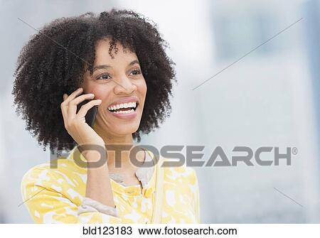Stock Image - African American talking on cell phone. Fotosearch