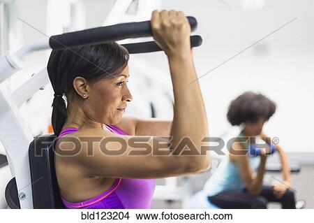 Picture - African American woman working out in gym. Fotosearch