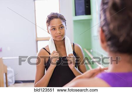 Stock Image - Ballerina talking with teacher in studio. Fotosearch