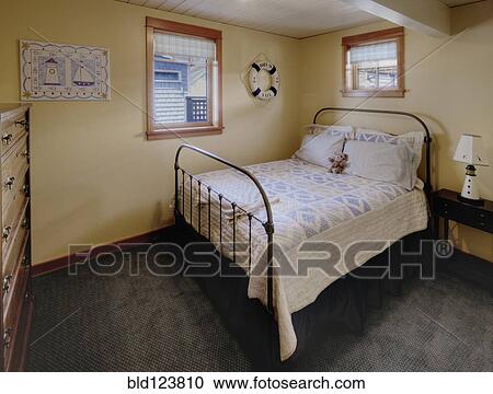 Stock Image - Bed and dresser in bedroom. Fotosearch