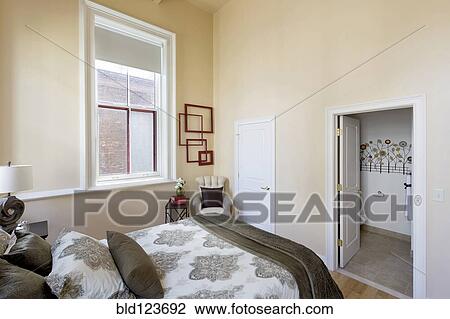 Bed and ensuite bathroom in bedroom View Large Photo Image Stock Image - Bed and ensuite bathroom in bedroom. Fotosearch