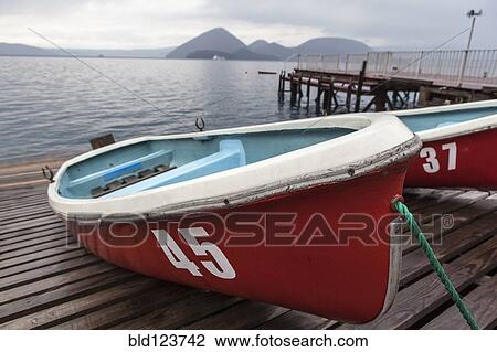 Boats on wooden dock View Large Photo Image Stock Image - Boats on wooden dock. Fotosearch
