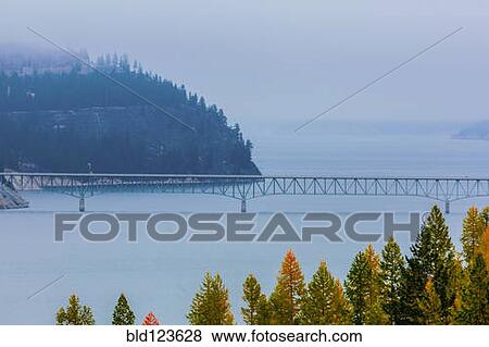Bridge spanning river, Koocanusa Bridge, Rexford, Montana, United States View Large Photo Image Stock Photo - Bridge spanning river, Koocanusa Bridge, Rexford, Montana, United States. Fotosearch