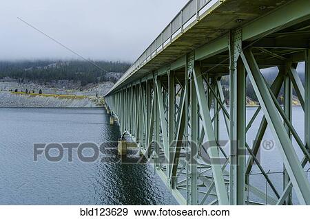 Bridge spanning river, Koocanusa Bridge, Rexford, Montana, United States View Large Photo Image Stock Photo - Bridge spanning river, Koocanusa Bridge, Rexford, Montana, United States. Fotosearch