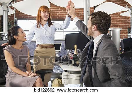 Business people high fiving in office View Large Photo Image Stock Image - Business people high fiving in office. Fotosearch