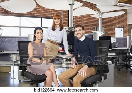 Business people smiling in office View Large Photo Image Picture - Business people smiling in office. Fotosearch