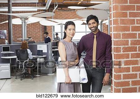 Stock Photo - Business people smiling in office. Fotosearch