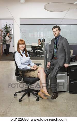 Business people smiling in office View Large Photo Image Stock Photograph - Business people smiling in office. Fotosearch