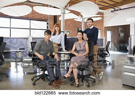 Stock Photography - Business people smiling in office. Fotosearch