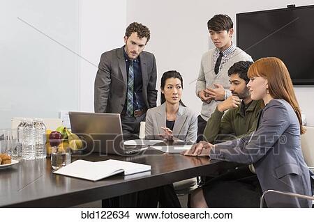 Picture - Business people talking in meeting. Fotosearch