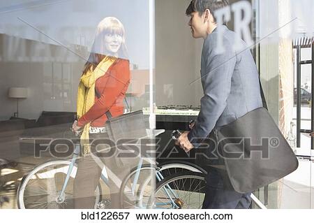 Business people wheeling bicycles in office View Large Photo Image Stock Photo - Business people wheeling bicycles in office. Fotosearch