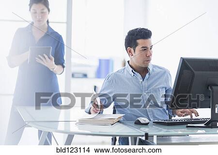 Picture - Business people working in office. Fotosearch