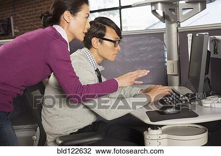 Stock Image - Business people working together in office. Fotosearch