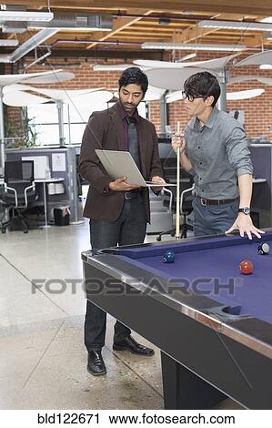 Businessmen talking in office lounge area View Large Photo Image Stock Image - Businessmen talking in office lounge area. Fotosearch