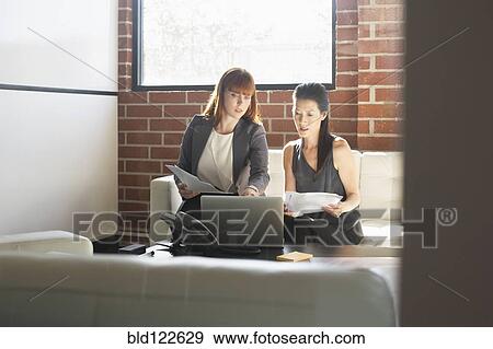 Businesswomen working together in office View Large Photo Image Stock Photo - Businesswomen working together in office. Fotosearch
