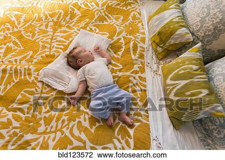 Caucasian baby laying on bed View Large Photo Image Stock Image - Caucasian baby laying on bed. Fotosearch